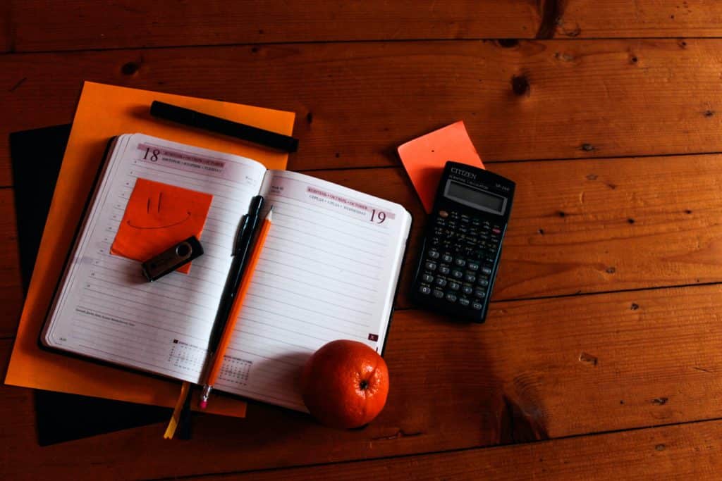 photo of journal and calculator on desk